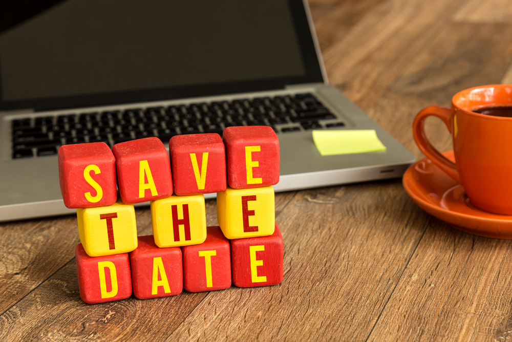Save the Date on a wood cube in a corporate background Save the Date on a wood cube in a corporate background